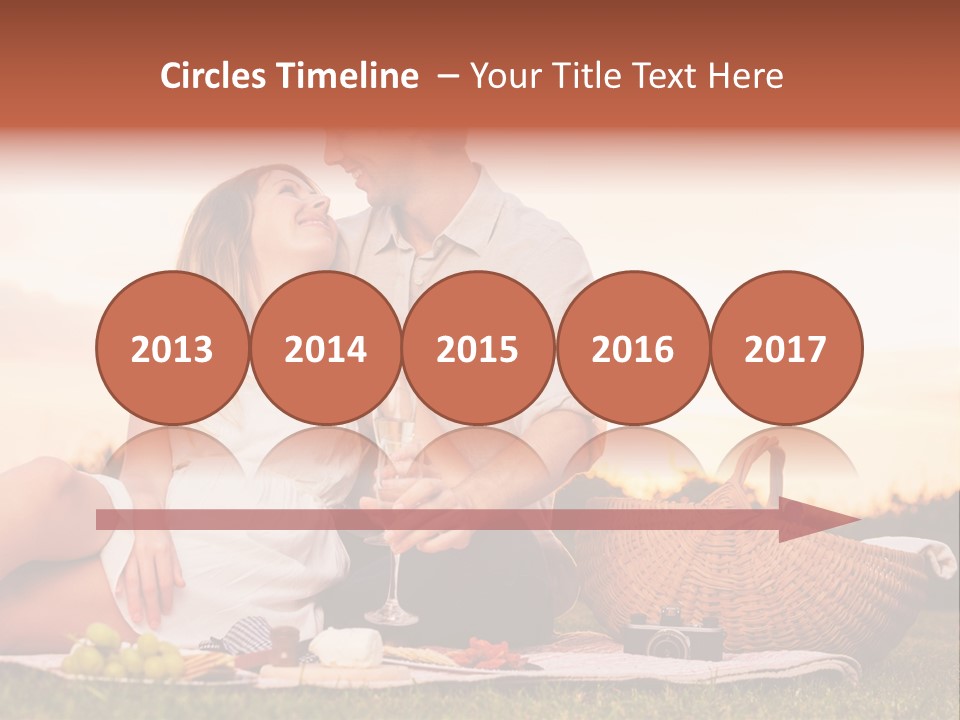 A Man And A Woman Sitting On A Blanket With A Bottle Of Champagne PowerPoint Template