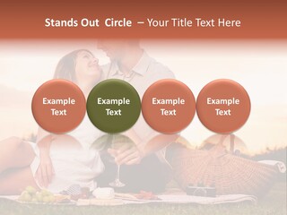 A Man And A Woman Sitting On A Blanket With A Bottle Of Champagne PowerPoint Template