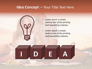 A Man And A Woman Sitting On A Blanket With A Bottle Of Champagne PowerPoint Template