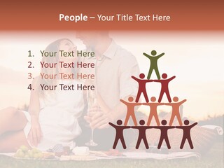 A Man And A Woman Sitting On A Blanket With A Bottle Of Champagne PowerPoint Template