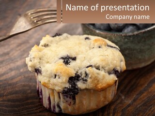 A Blueberry Muffin Sitting On Top Of A Wooden Table PowerPoint Template