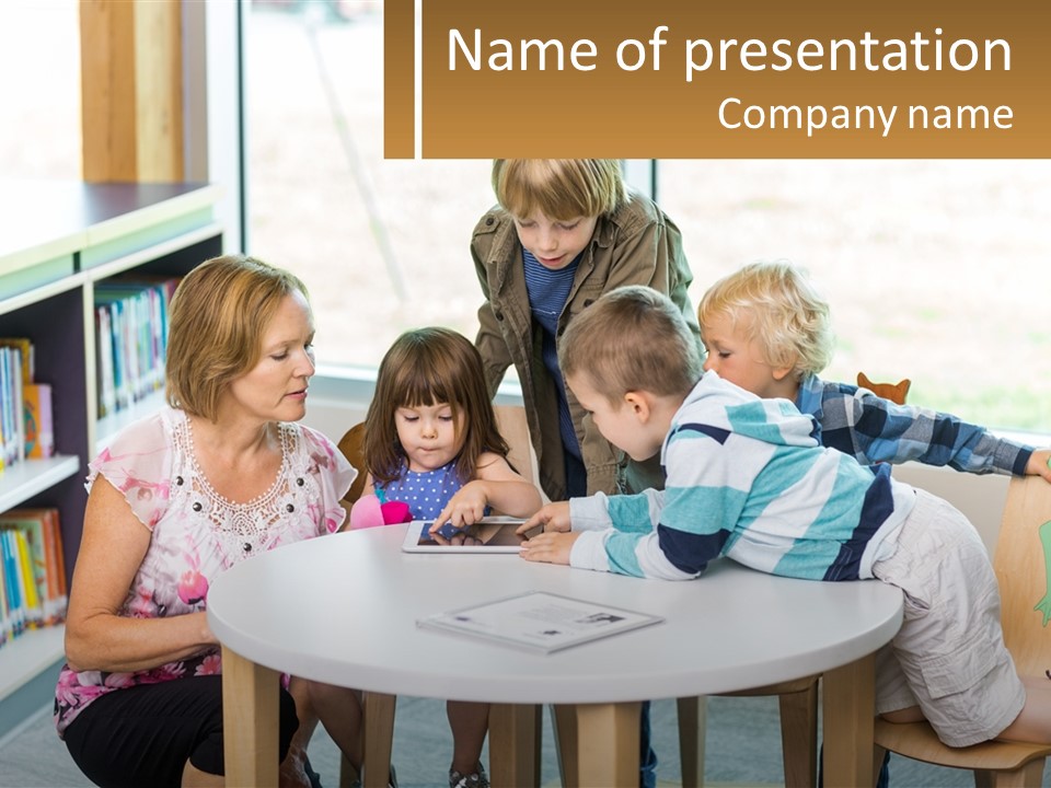 A Group Of Children Sitting Around A Table PowerPoint Template