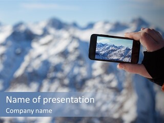 A Person Taking A Picture Of A Mountain With A Cell Phone PowerPoint Template
