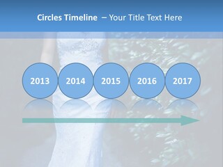 A Woman In A White Dress Is Walking Down A Path PowerPoint Template