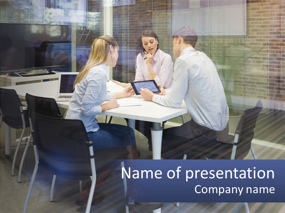 A Group Of People Sitting Around A Table With A Tablet PowerPoint Template