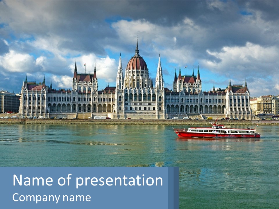 A Red Boat Is In The Water Near A Large Building PowerPoint Template