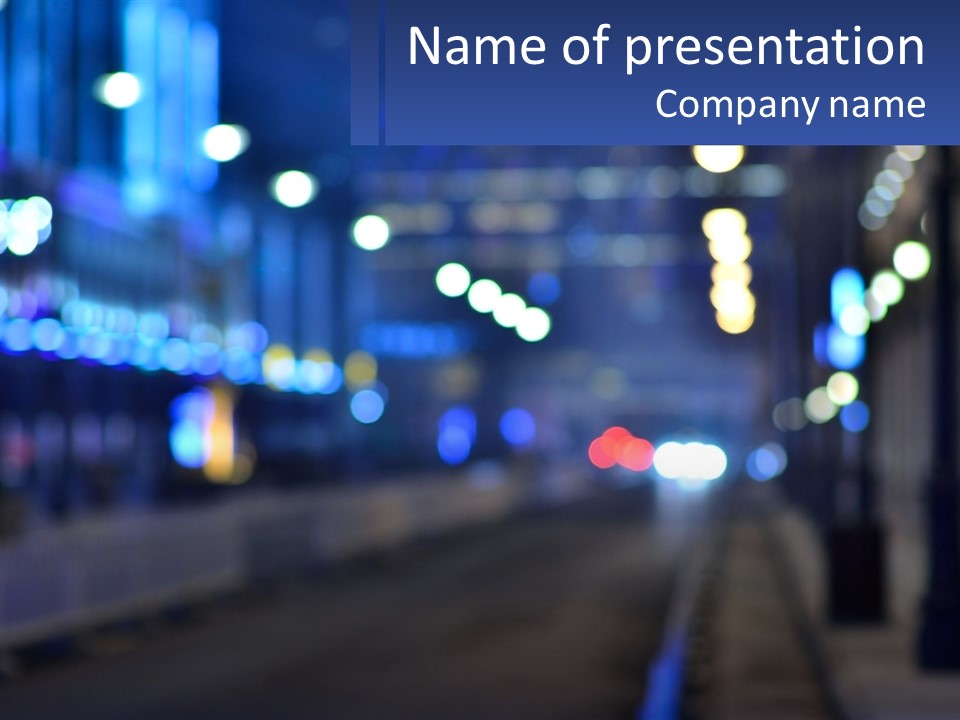 A Blurry Photo Of A City Street At Night PowerPoint Template