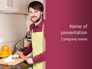 A Man Standing In A Kitchen Preparing Food PowerPoint Template