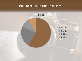 A Camera Sitting On Top Of A Wooden Table PowerPoint Template