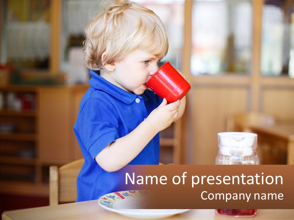 A Little Boy Drinking From A Red Cup PowerPoint Template