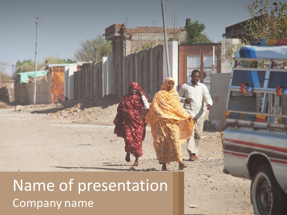 A Couple Of People Walking Down A Dirt Road PowerPoint Template