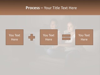 Two Girls Sitting On A Couch Watching A Movie PowerPoint Template