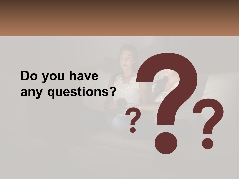 Two Girls Sitting On A Couch Watching A Movie PowerPoint Template