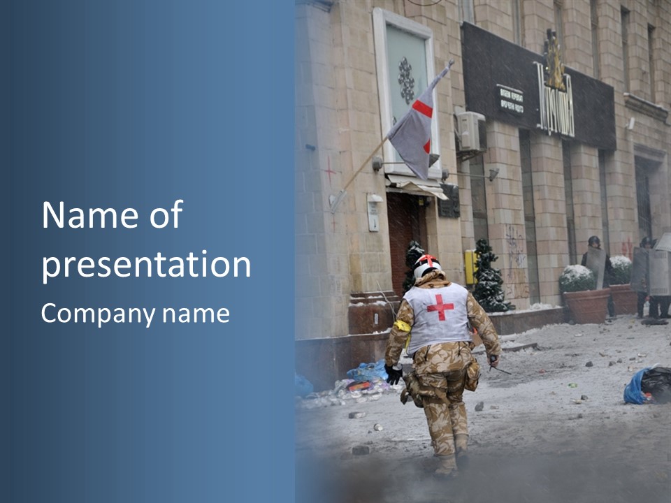 A Man Walking Down A Street In Front Of A Building PowerPoint Template