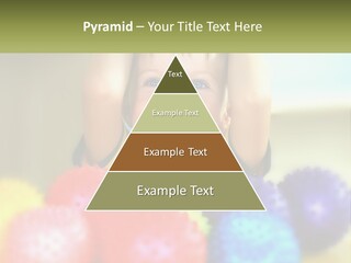 A Young Boy Is Holding His Head Above A Pile Of Balls PowerPoint Template