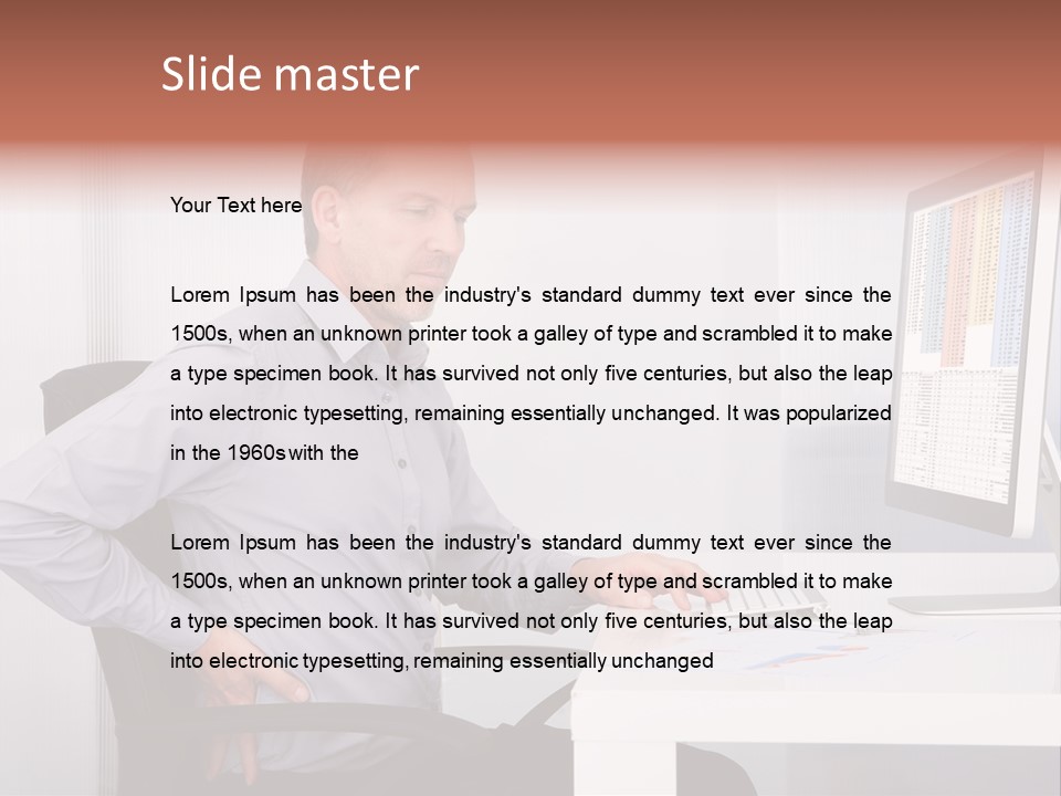 A Man Sitting At A Desk Using A Computer PowerPoint Template