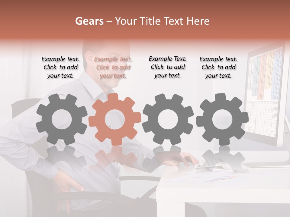 A Man Sitting At A Desk Using A Computer PowerPoint Template