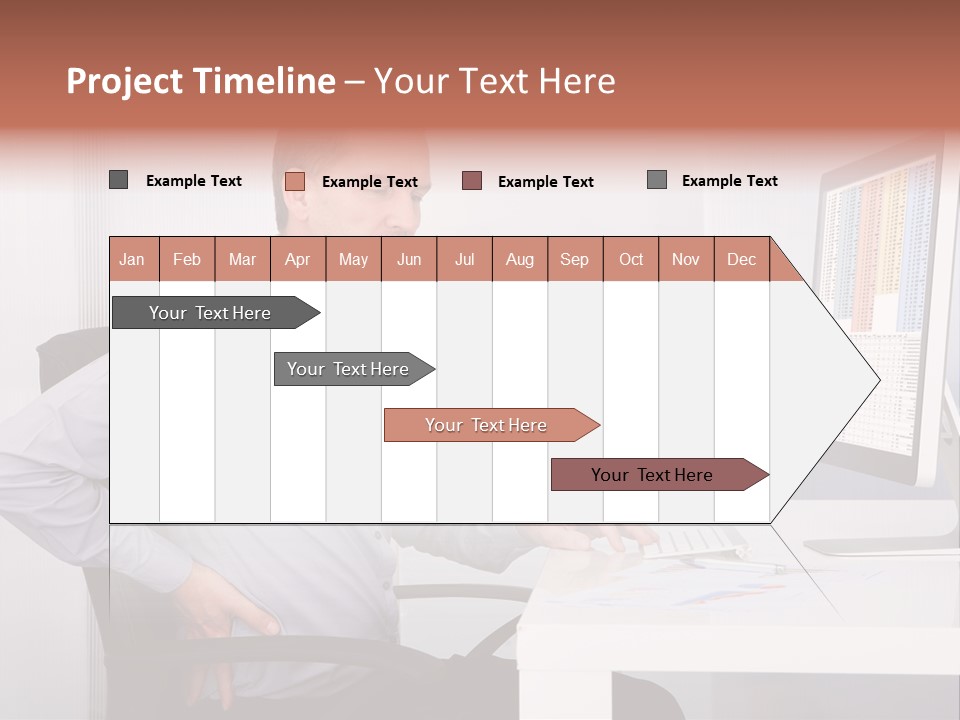 A Man Sitting At A Desk Using A Computer PowerPoint Template