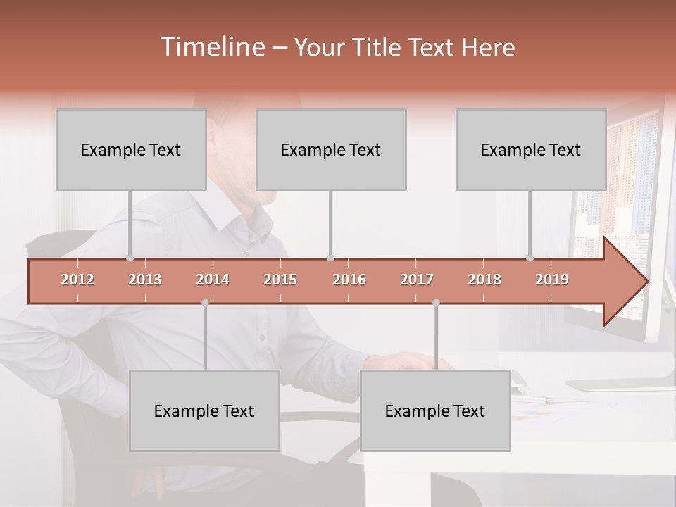 A Man Sitting At A Desk Using A Computer PowerPoint Template