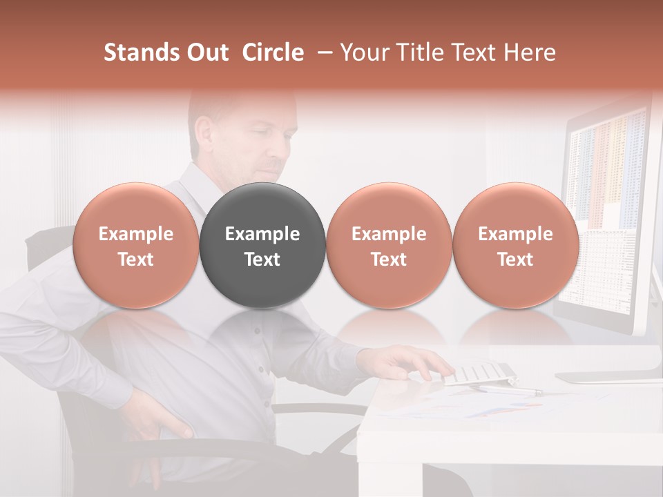 A Man Sitting At A Desk Using A Computer PowerPoint Template