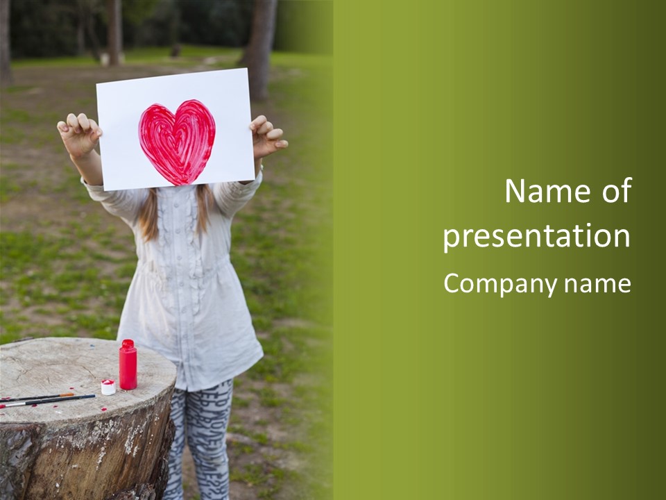 A Girl Holding A Piece Of Paper With A Heart Drawn On It PowerPoint Template