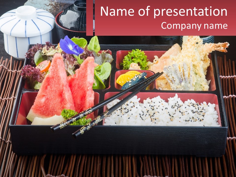 A Tray Of Food With Chopsticks And Watermelon PowerPoint Template