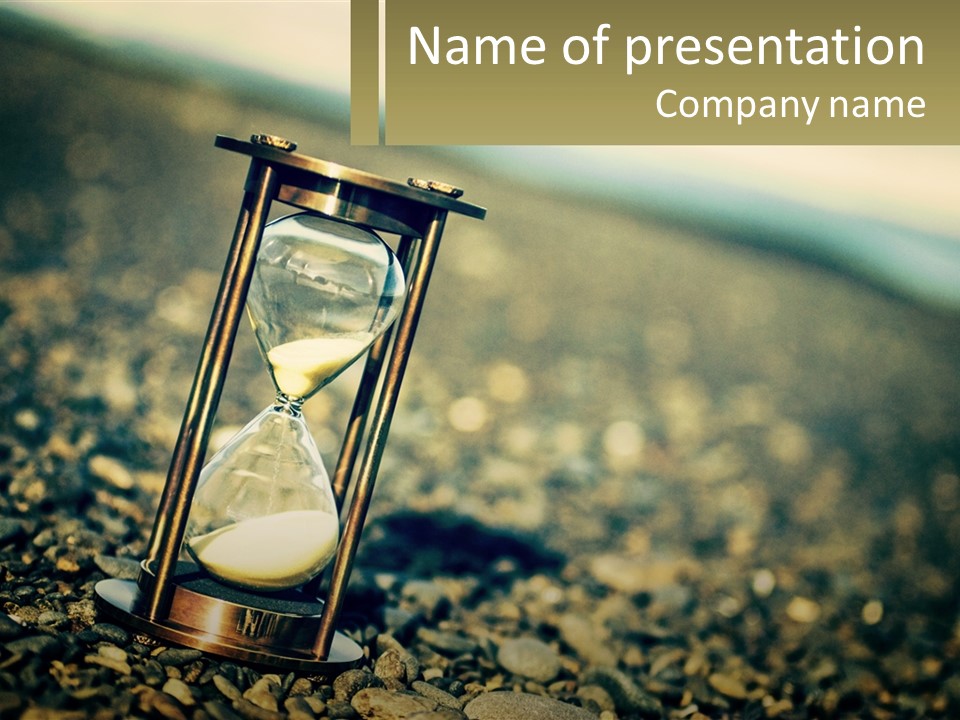 An Hourglass Sitting On Top Of A Pile Of Rocks PowerPoint Template