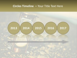 An Hourglass Sitting On Top Of A Pile Of Rocks PowerPoint Template