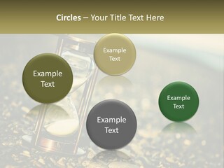 An Hourglass Sitting On Top Of A Pile Of Rocks PowerPoint Template