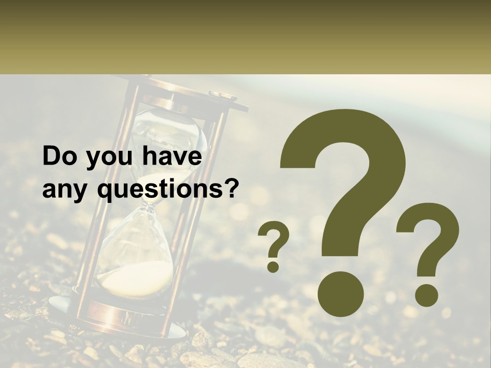 An Hourglass Sitting On Top Of A Pile Of Rocks PowerPoint Template