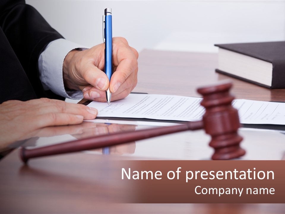 A Person Signing A Document On A Desk PowerPoint Template