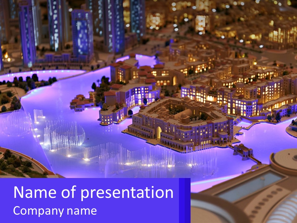 A Model Of A City At Night With A Fountain PowerPoint Template