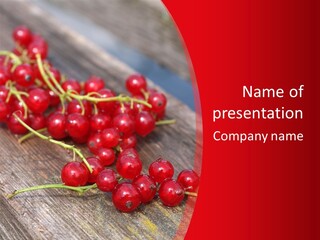 A Bunch Of Red Berries Sitting On Top Of A Wooden Table PowerPoint Template