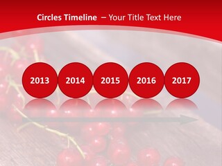 A Bunch Of Red Berries Sitting On Top Of A Wooden Table PowerPoint Template