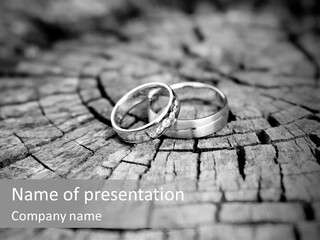 Two Wedding Rings Sitting On Top Of A Brick Floor PowerPoint Template