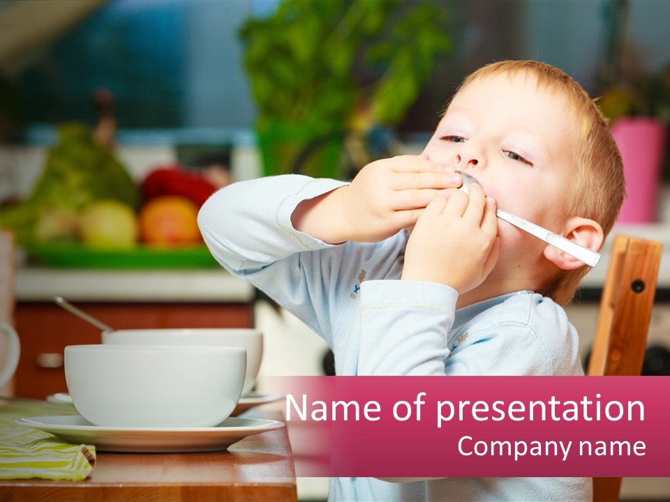 A Young Boy Is Eating A Piece Of Food PowerPoint Template