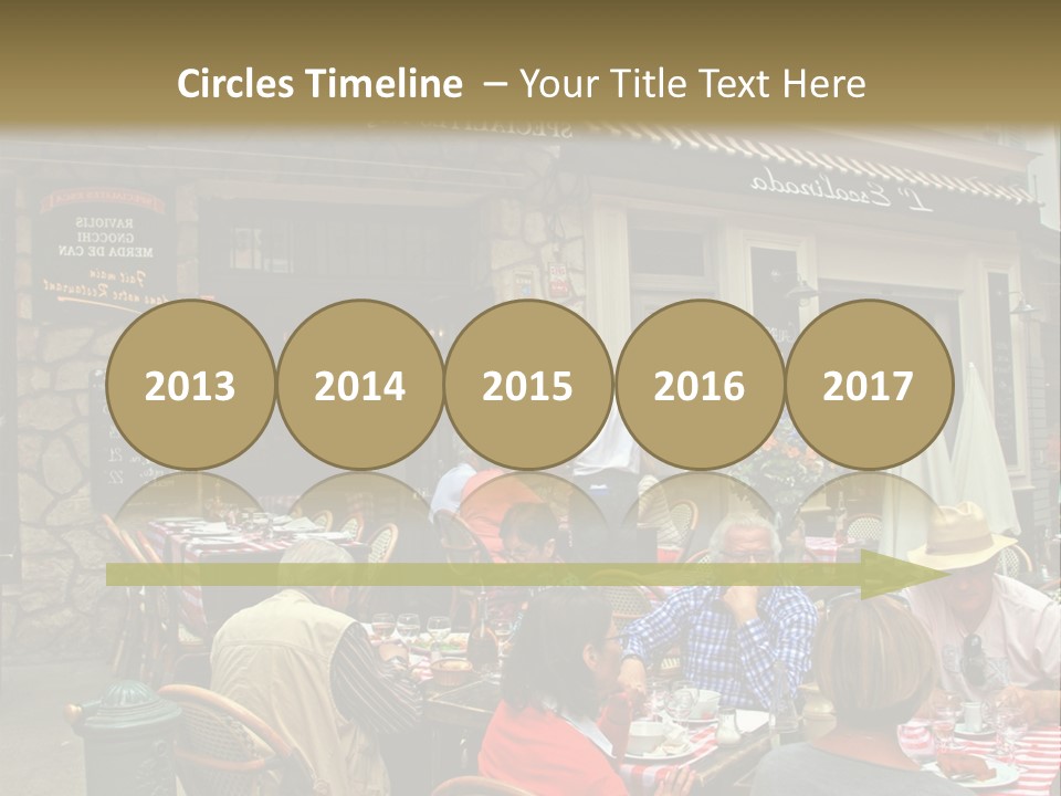 A Group Of People Sitting At A Table In Front Of A Building PowerPoint Template