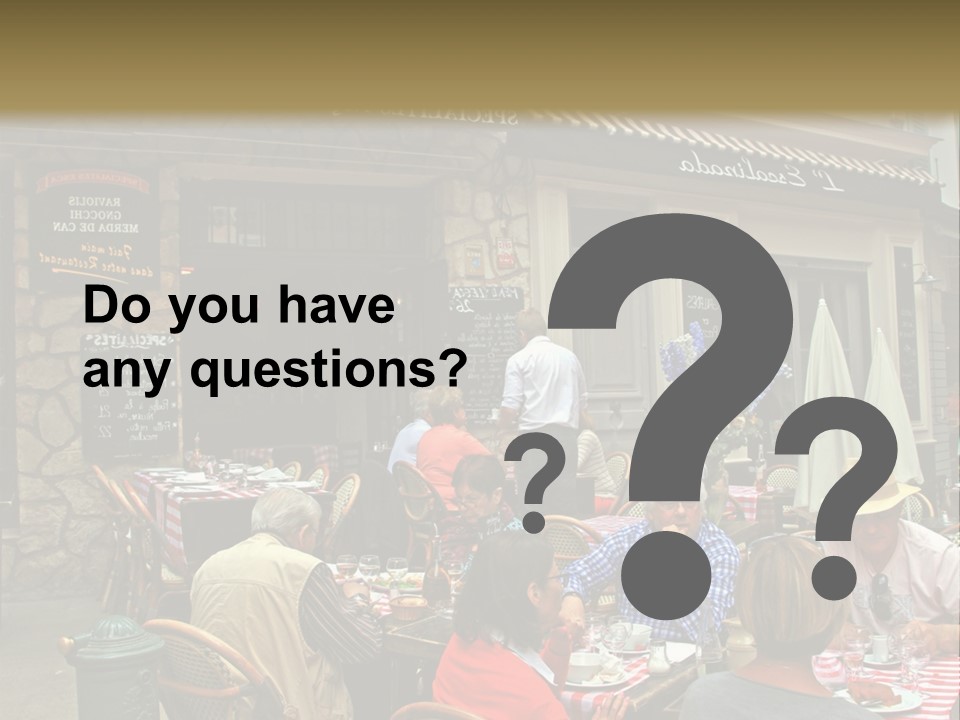 A Group Of People Sitting At A Table In Front Of A Building PowerPoint Template