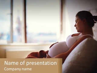 A Pregnant Woman Sitting On A Couch In A Room PowerPoint Template