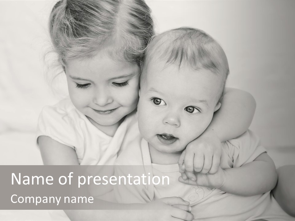 Two Little Girls Hugging Each Other On A Bed PowerPoint Template