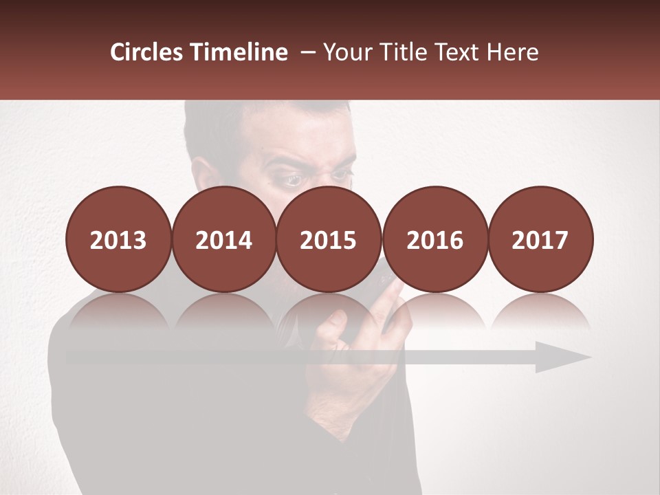 A Man Holding A Cell Phone In His Hand PowerPoint Template