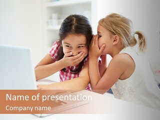 Two Young Girls Sitting In Front Of A Laptop Computer PowerPoint Template