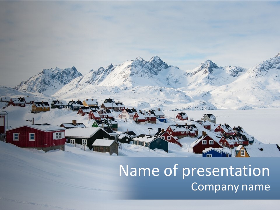 A Snowy Town With Mountains In The Background PowerPoint Template