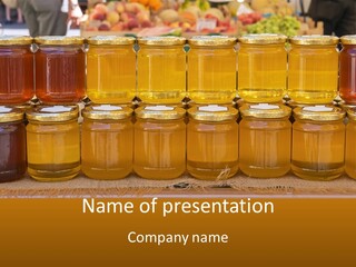 Many Jars Of Honey On A Table With People In The Background PowerPoint Template