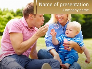 A Man And A Woman Are Sitting On The Grass With A Baby PowerPoint Template