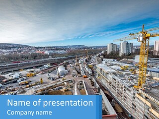 A Construction Site With A Crane In The Background PowerPoint Template