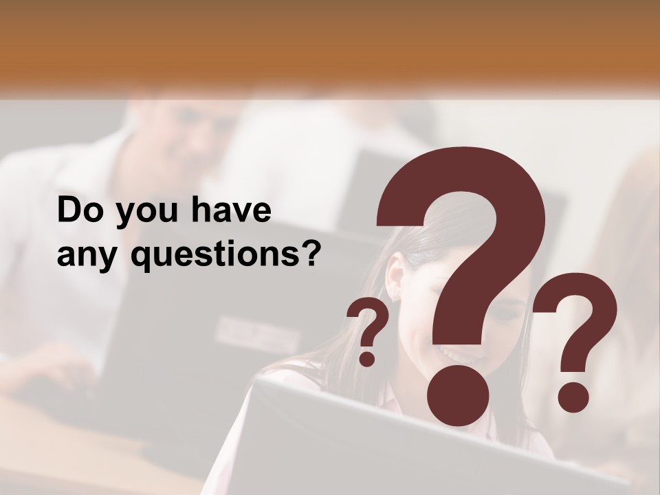 A Group Of People Working On Computers In An Office PowerPoint Template