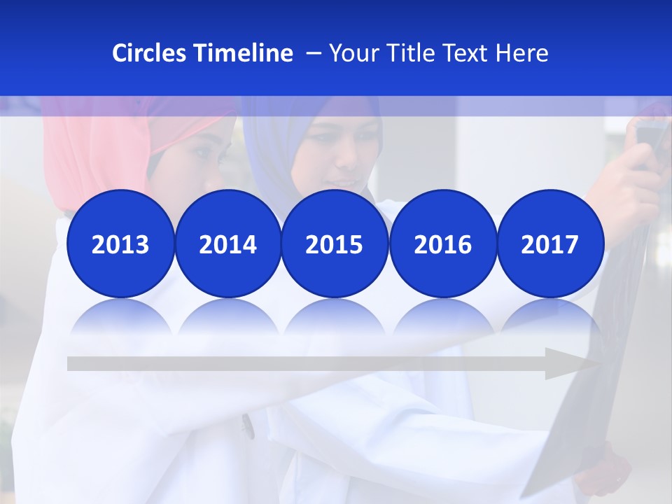 Two Women In Hijabs Are Looking At Something PowerPoint Template