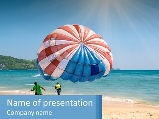 Two People Are Flying A Large Kite On The Beach PowerPoint Template