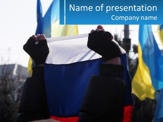 A Person Holding Up A Sign In Front Of Flags PowerPoint Template